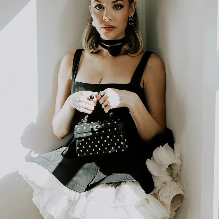 Elegant Black Mini Dress with Peplum and White Ruffle Accents for Upscale Casual Gatherings