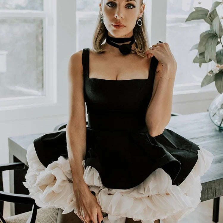 Elegant Black Mini Dress with Peplum and White Ruffle Accents for Upscale Casual Gatherings